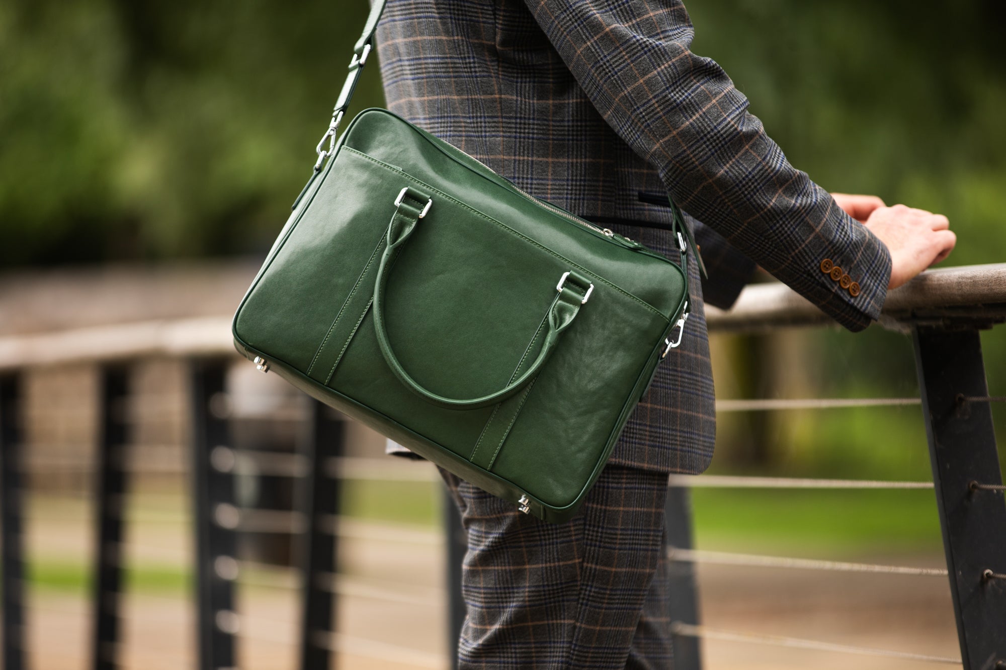 Lifestyle image of leather briefcase on shoulder 